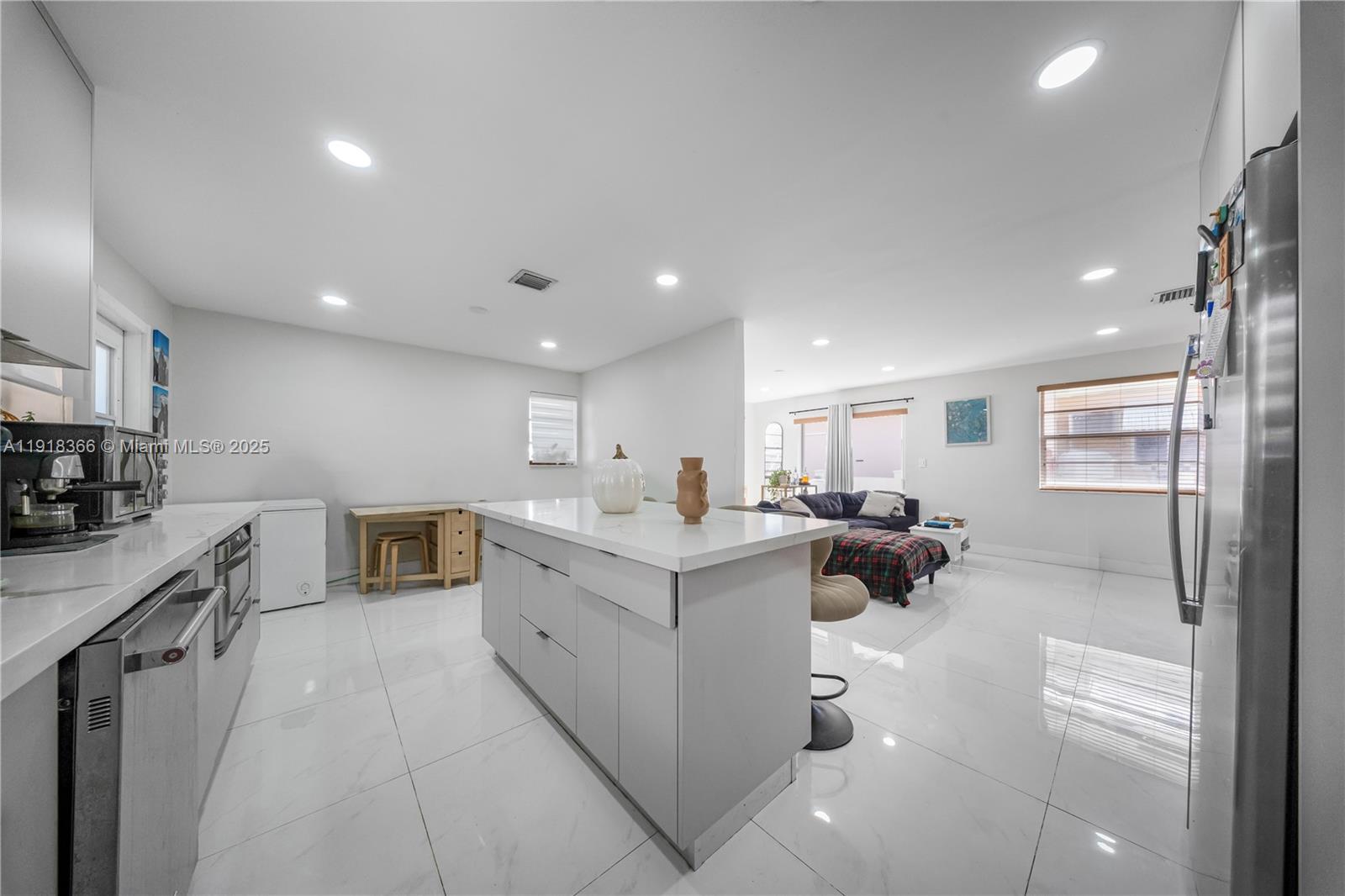 270 West 14th Street Hialeah, FL 33010 - Photo 12 of 18 a view of a kitchen with kitchen island a sink a counter top stainless steel appliances and cabinets