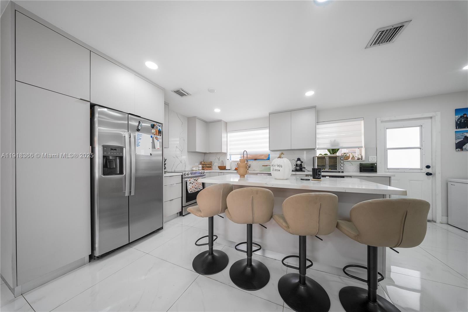 270 West 14th Street Hialeah, FL 33010 - Photo 13 of 18 a kitchen with stainless steel appliances granite countertop a refrigerator and a sink