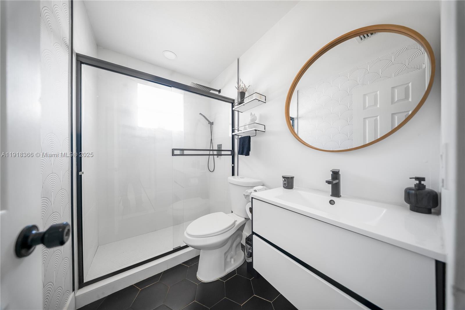 270 West 14th Street Hialeah, FL 33010 - Photo 14 of 18 a bathroom with a toilet a sink and a mirror