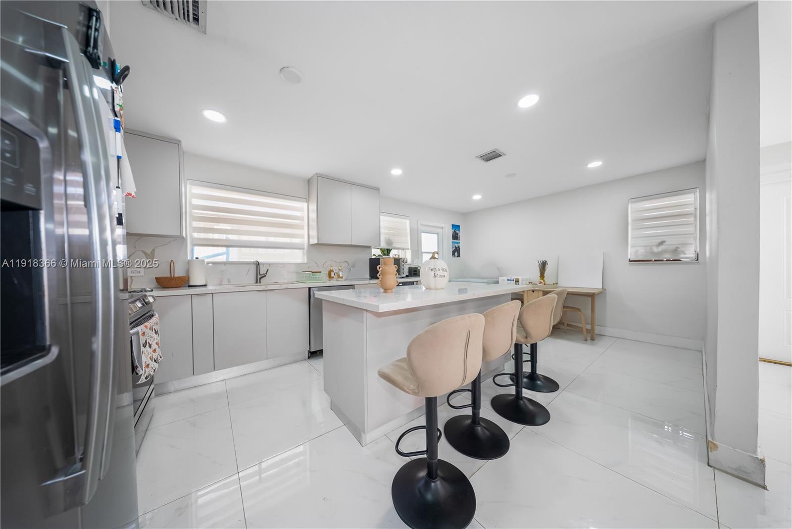 270 West 14th Street Hialeah, FL 33010 - Photo 8 of 18 a kitchen with white cabinets and stainless steel appliances