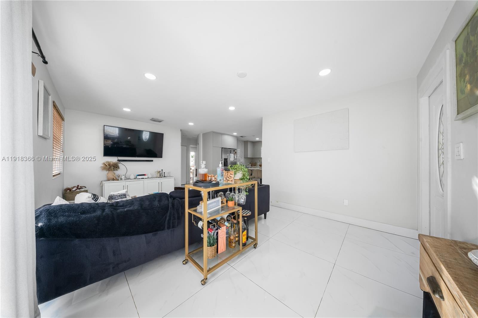 270 West 14th Street Hialeah, FL 33010 - Photo 10 of 18 a living room with furniture and a flat screen tv