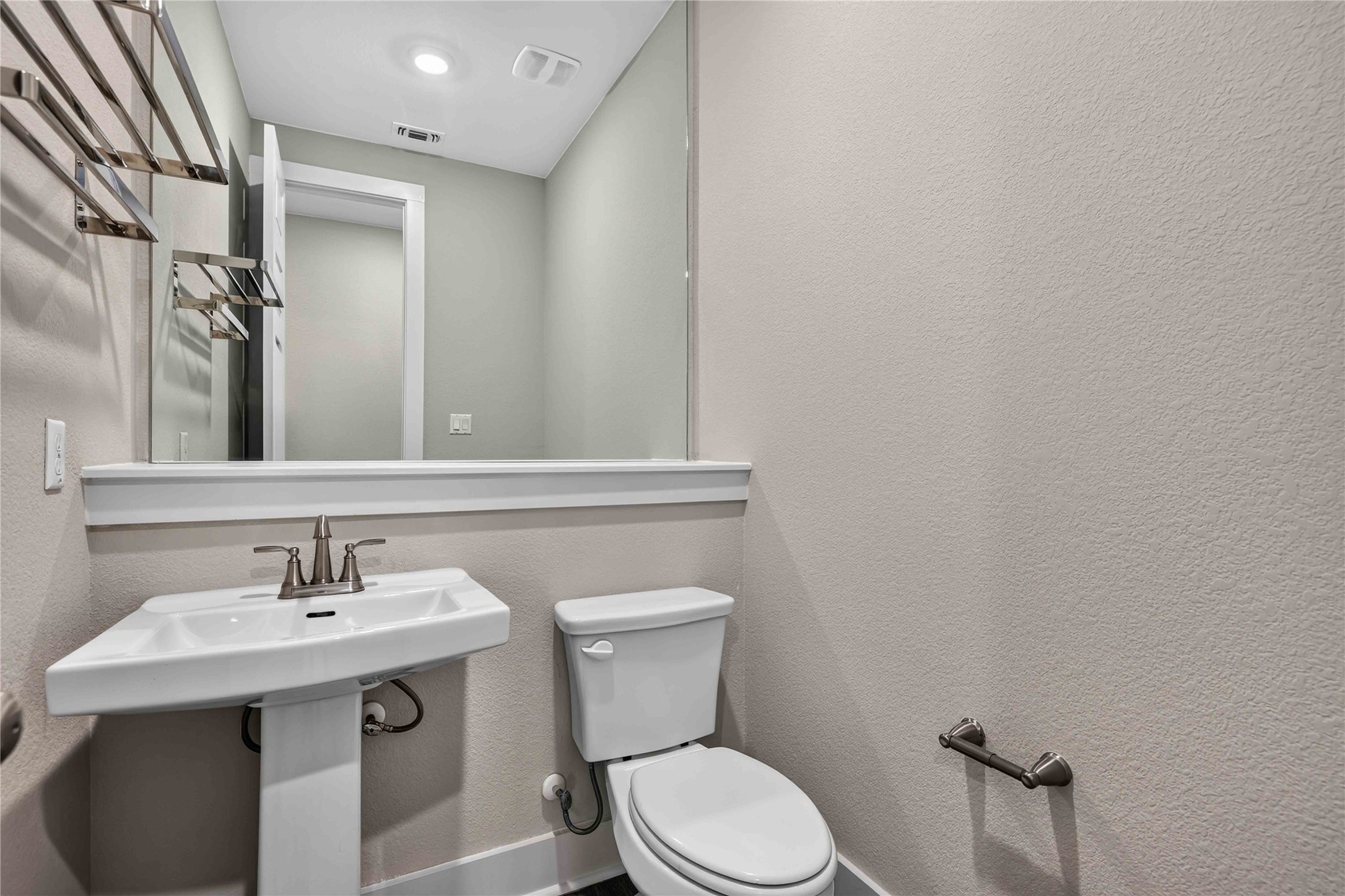 605 A Mallow Road Leander, TX 78641 - Photo 16 of 29 A compact powder room with a sleek pedestal sink and contemporary mirror.