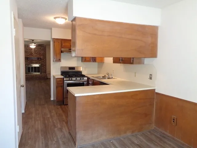 a kitchen with a sink a stove and a refrigerator