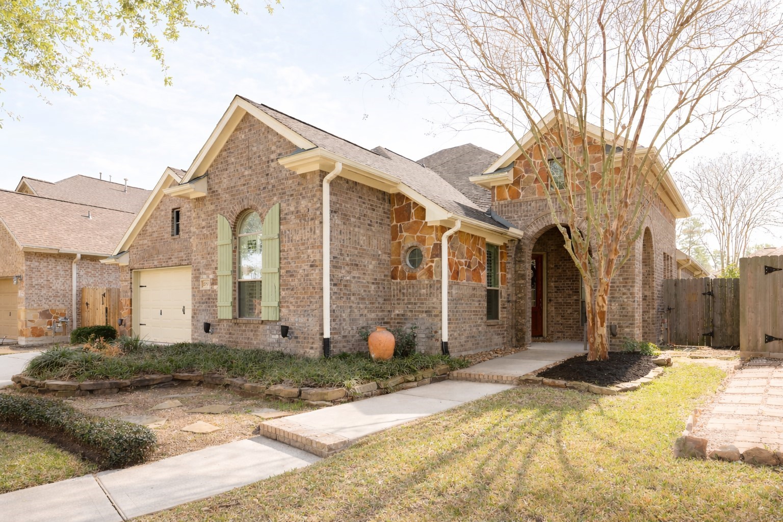 Beautiful brick and stone facade leads to a charming front porch entry.