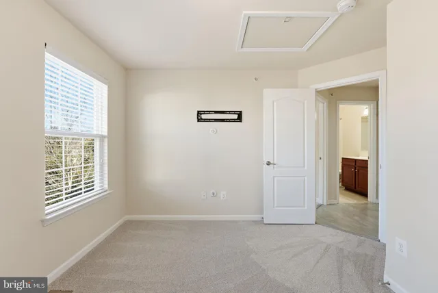 an empty room with windows and closet