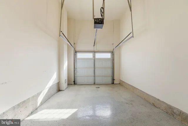 an empty room with furniture and natural light