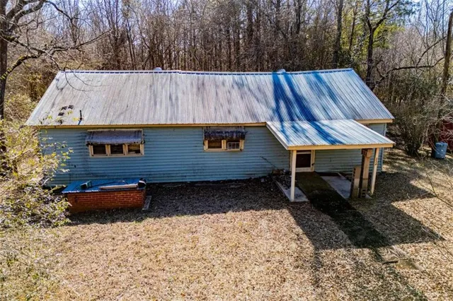 a backyard of a house with barbeque oven