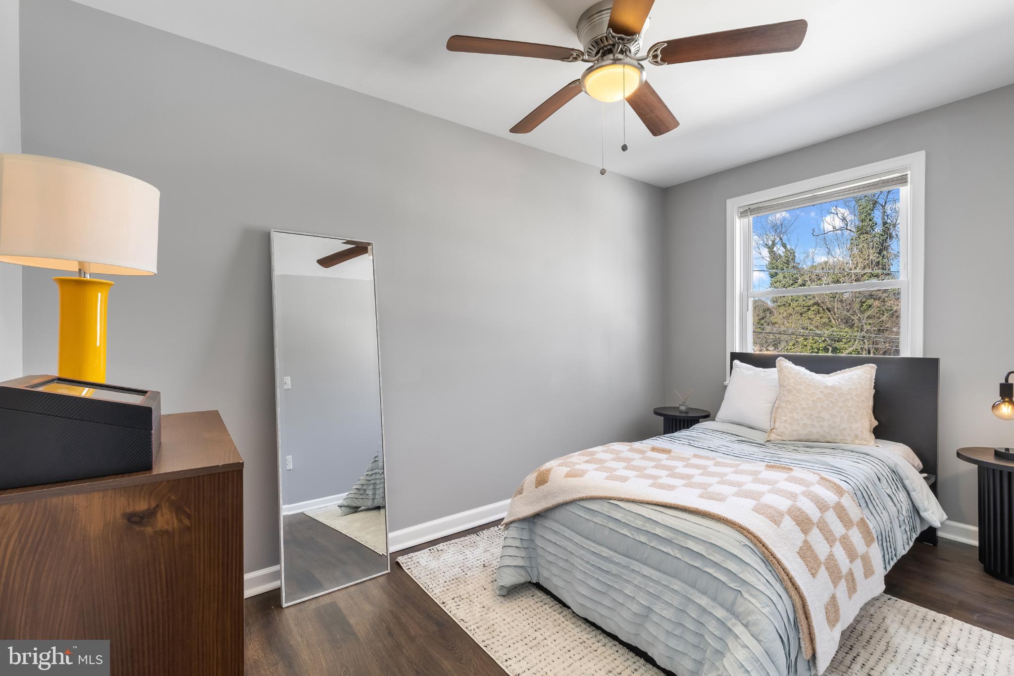 1002 West 43rd Street Baltimore, MD 21211 - Photo 12 of 23 a bedroom with a bed and a chandelier
