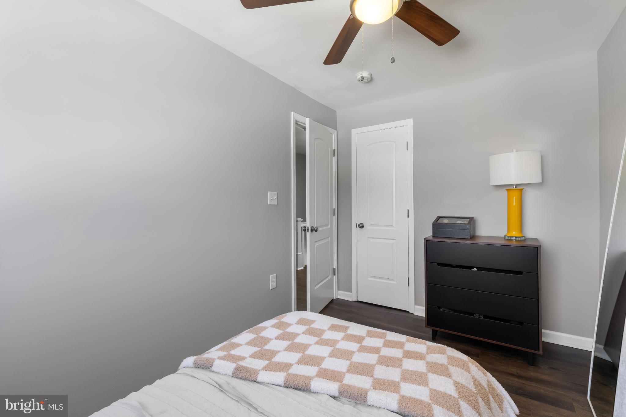 1002 West 43rd Street Baltimore, MD 21211 - Photo 13 of 23 a bedroom with a bed and a lamp on the dresser