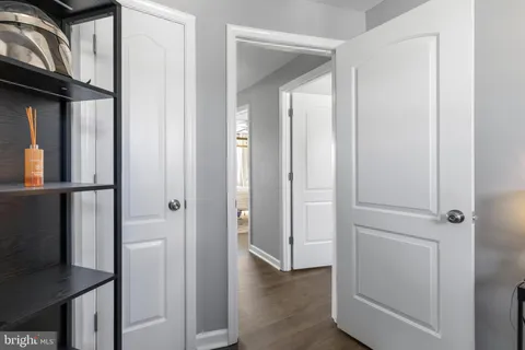a view of a hallway with wooden floor and staircase