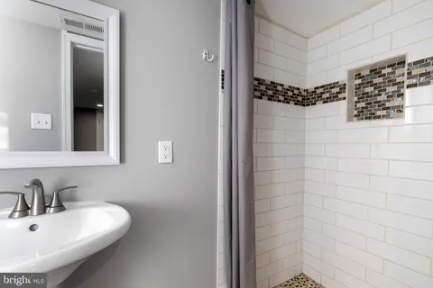 a bathroom with a bathtub and shower