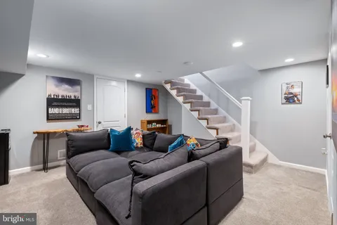 a living room with furniture and stairs