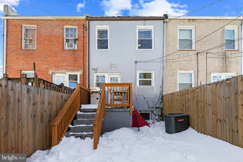 a view of a patio with table and chairs