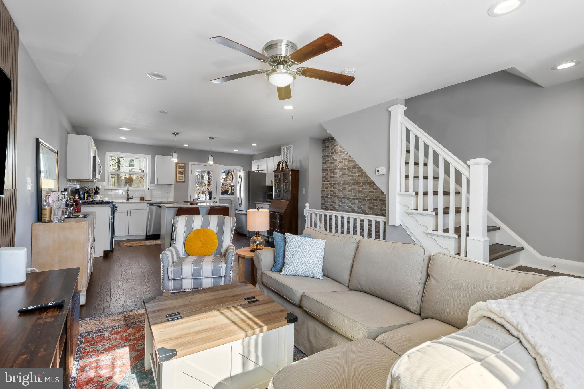 1002 West 43rd Street Baltimore, MD 21211 - Photo 4 of 23 a living room with furniture kitchen view and a chandelier