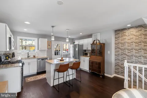 a kitchen with sink cabinets and wooden floor