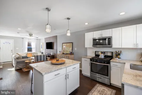 a kitchen with sink refrigerator and microwave