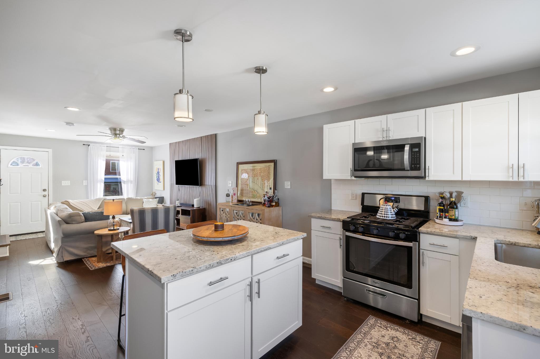 1002 West 43rd Street Baltimore, MD 21211 - Photo 9 of 23 a kitchen with sink refrigerator and microwave