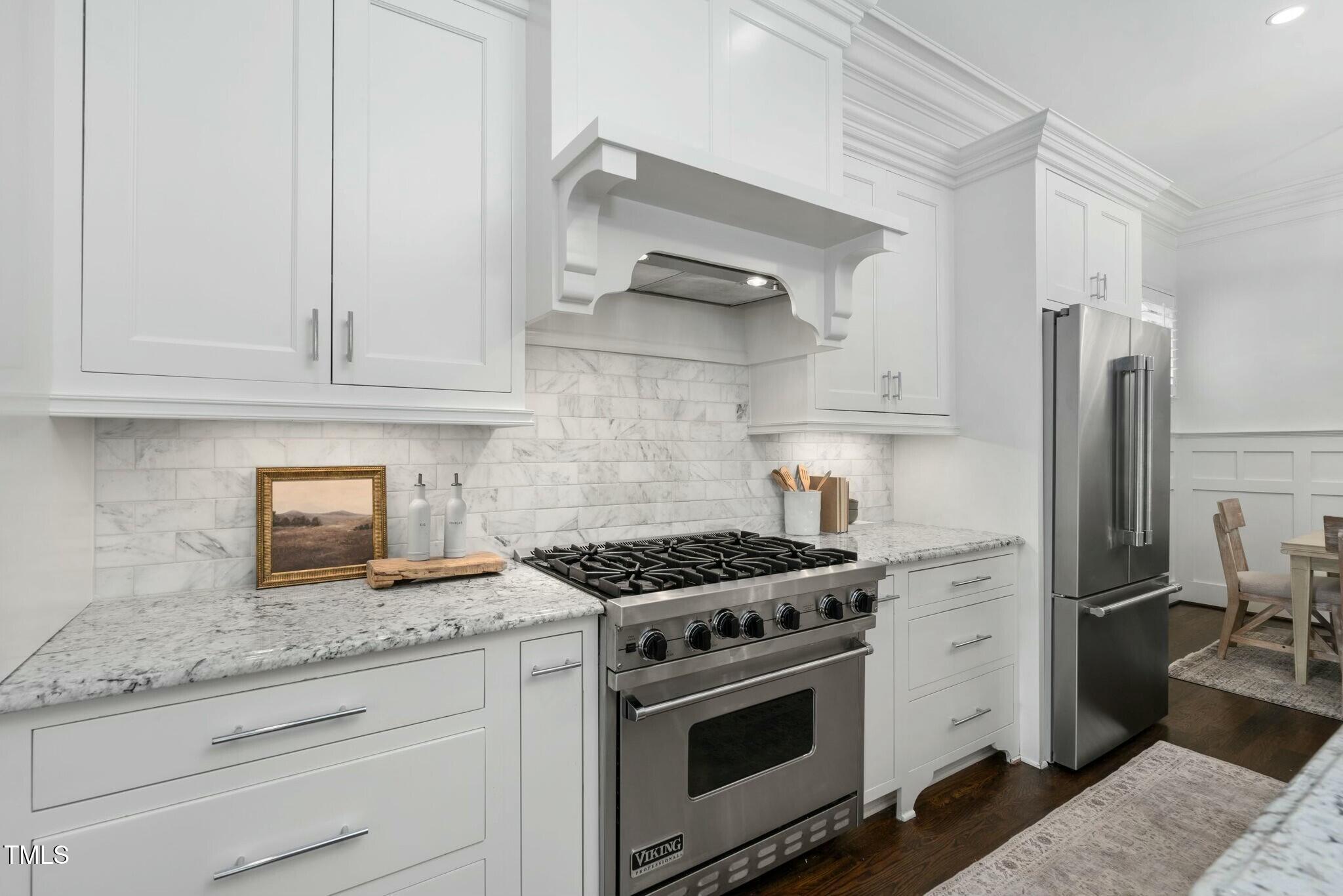 543 Guilford Circle Raleigh, NC 27608 - Photo 17 of 62 a kitchen with granite countertop cabinets and steel stainless steel appliances