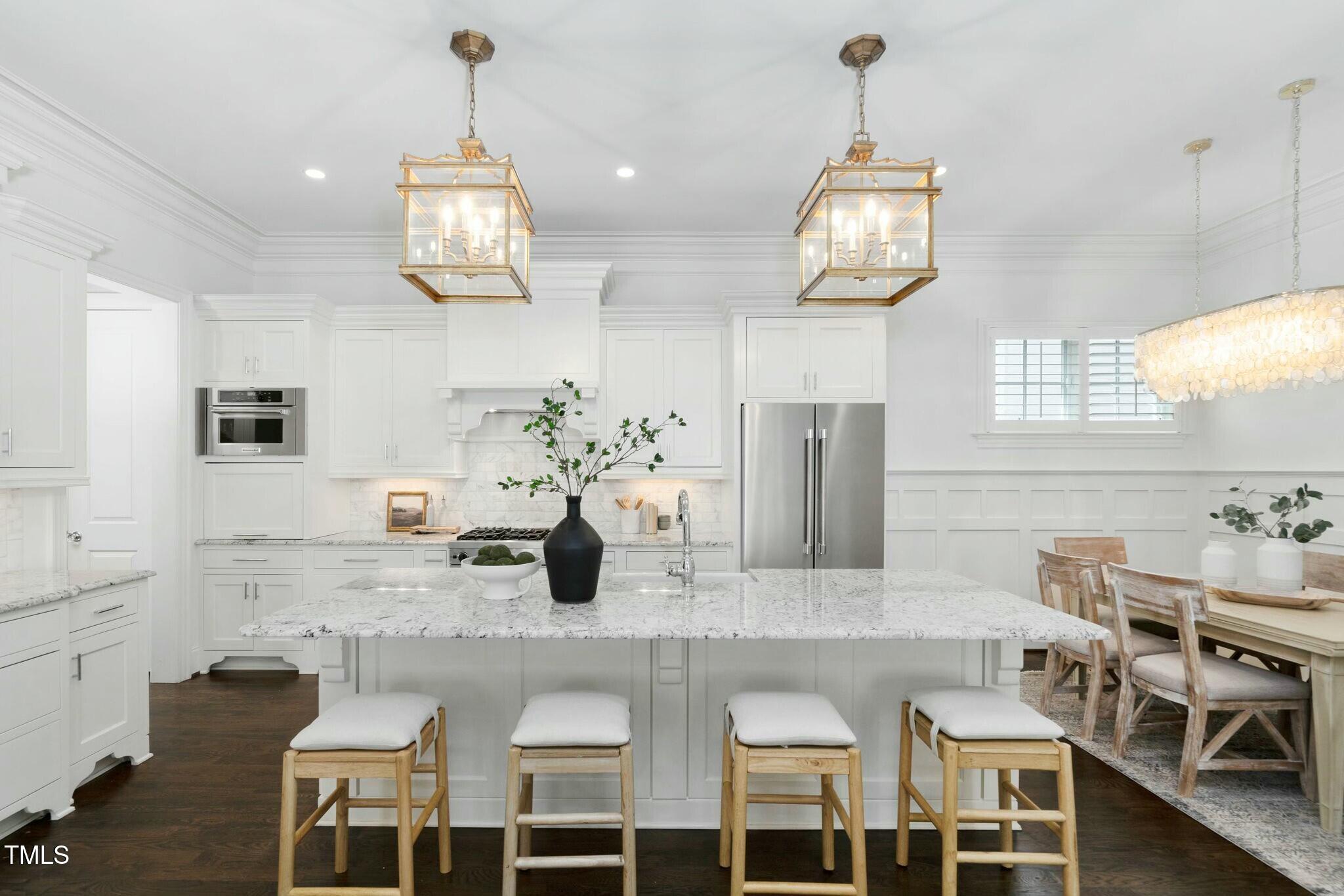 543 Guilford Circle Raleigh, NC 27608 - Photo 18 of 62 a kitchen with stainless steel appliances granite countertop a dining table chairs and white cabinets