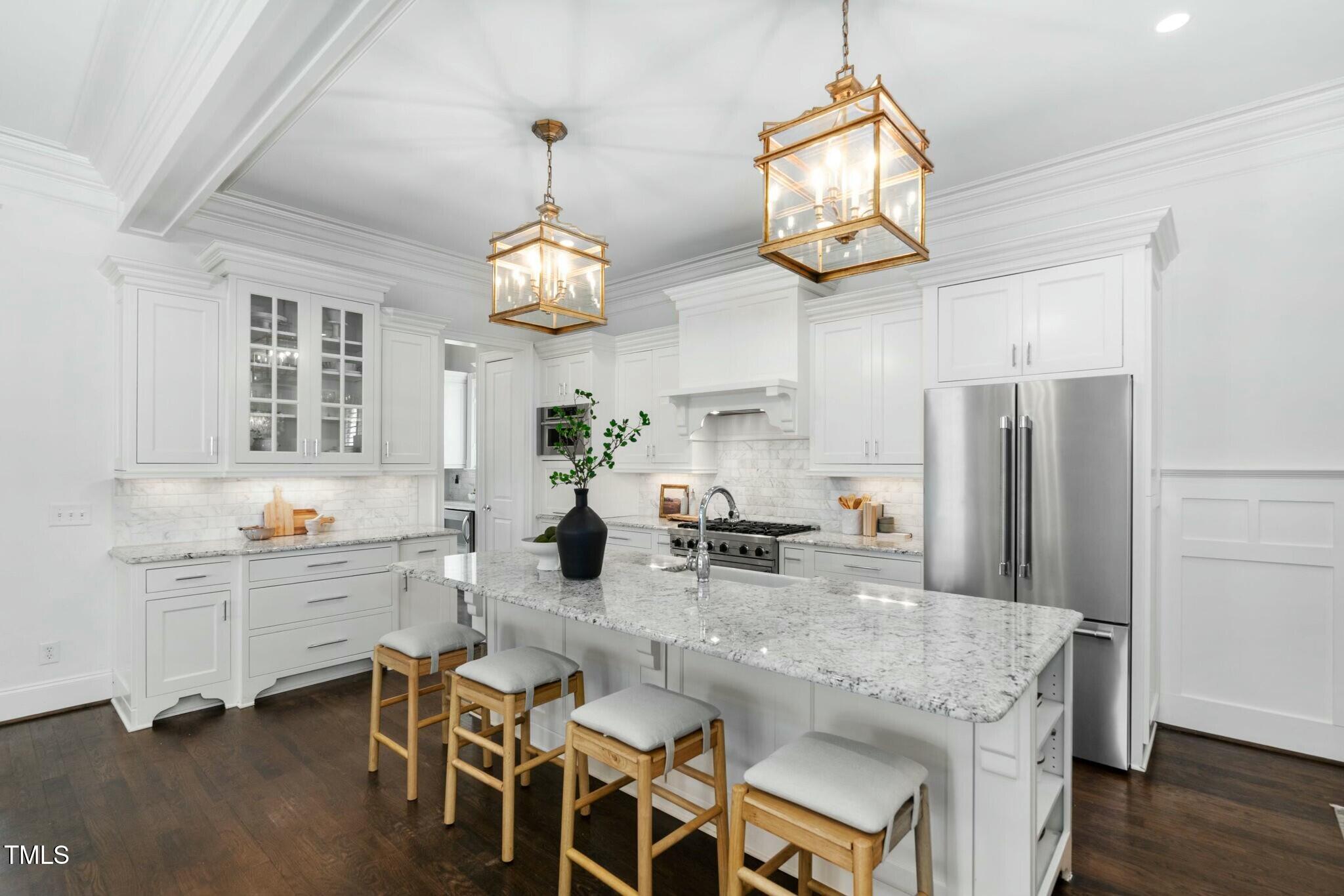 543 Guilford Circle Raleigh, NC 27608 - Photo 19 of 62 a kitchen with stainless steel appliances granite countertop a dining table chairs and chandelier