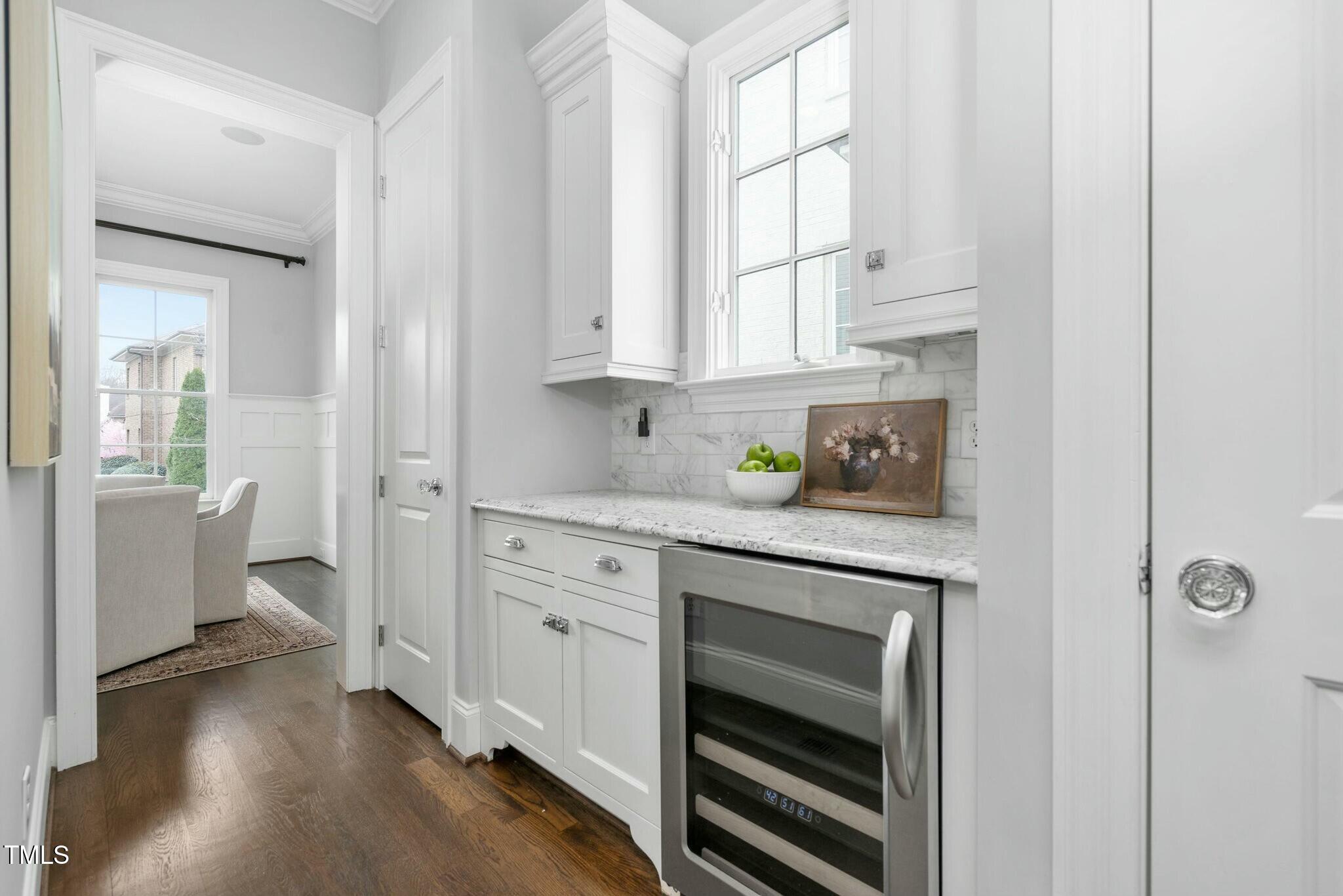 543 Guilford Circle Raleigh, NC 27608 - Photo 20 of 62 a kitchen with white cabinets and white appliances