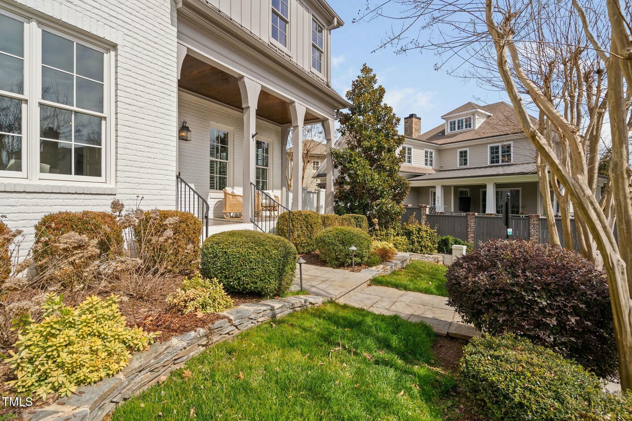 543 Guilford Circle Raleigh, NC 27608 - Photo 2 of 62 a front view of a house with a garden