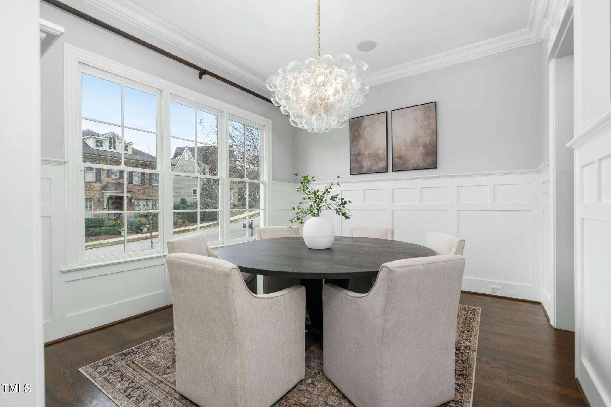 543 Guilford Circle Raleigh, NC 27608 - Photo 22 of 62 a view of a dining room with furniture wooden floor and chandelier