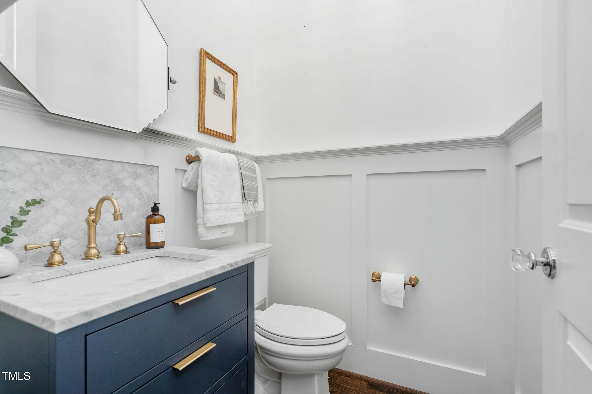 543 Guilford Circle Raleigh, NC 27608 - Photo 30 of 62 a bathroom with a granite countertop sink and a toilet