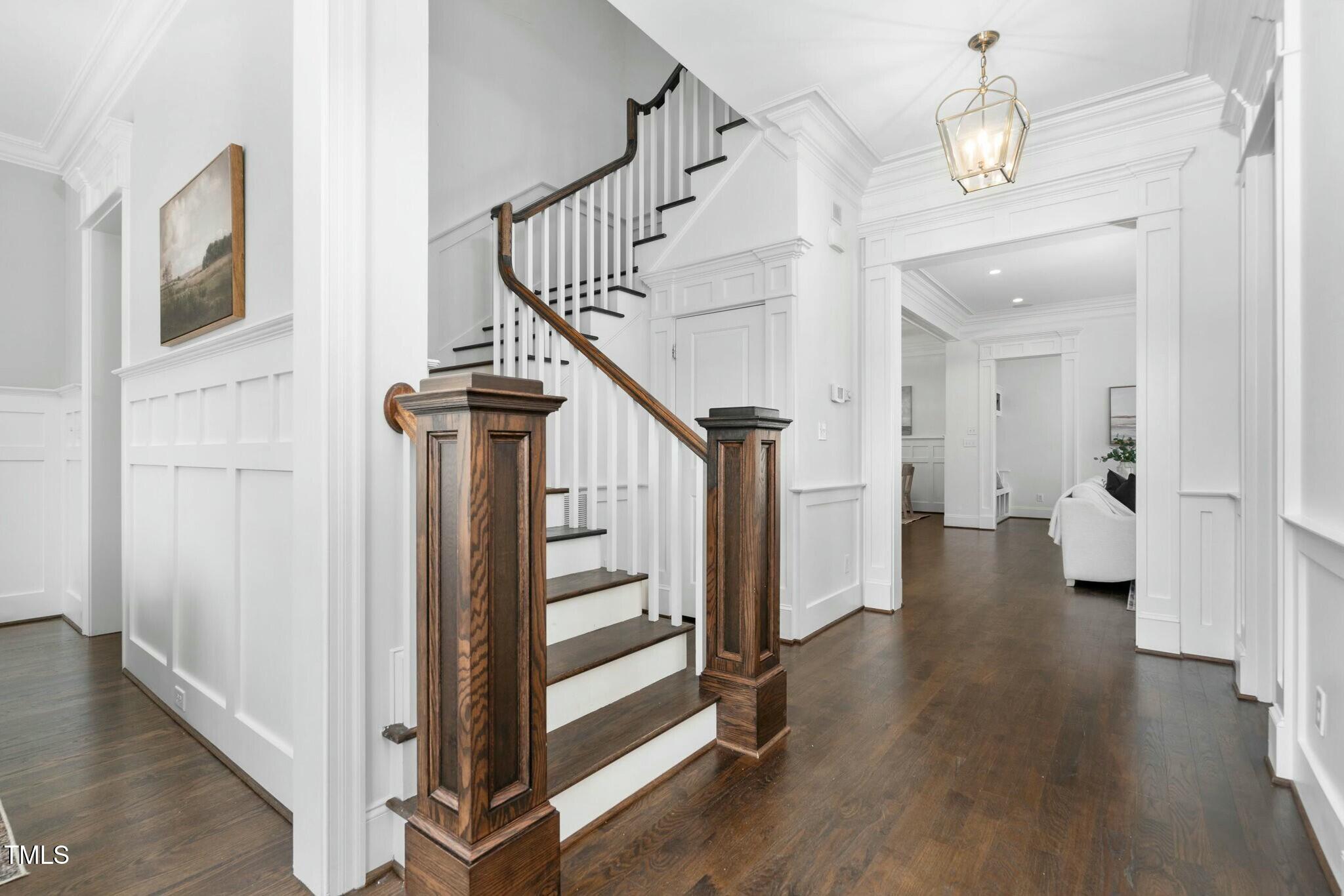 543 Guilford Circle Raleigh, NC 27608 - Photo 31 of 62 a view of a hallway with wooden floor and staircase
