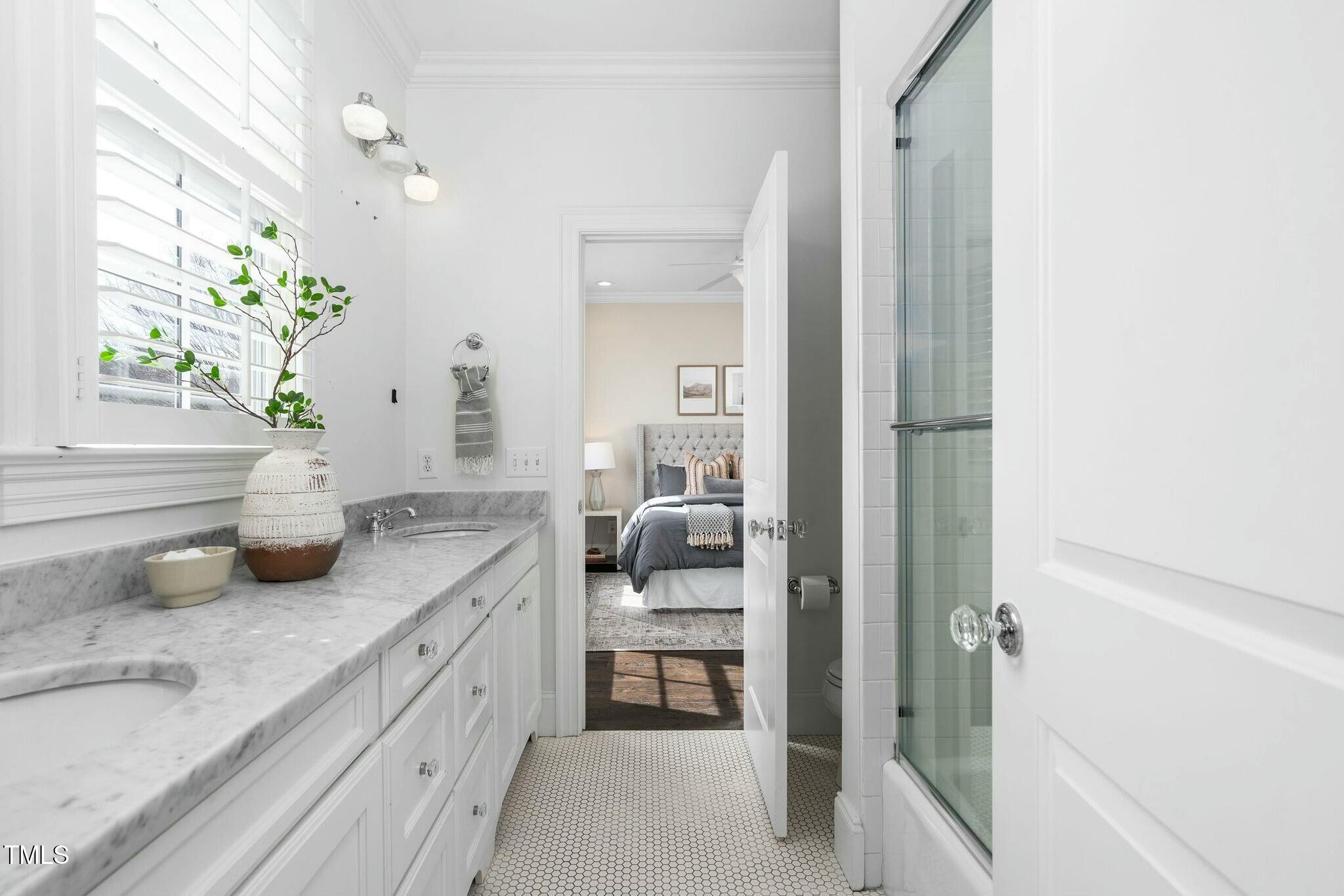 543 Guilford Circle Raleigh, NC 27608 - Photo 47 of 62 a spacious en suite bathroom with a granite countertop sink and a mirror