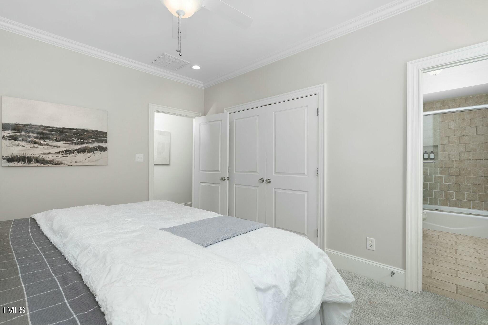 543 Guilford Circle Raleigh, NC 27608 - Photo 48 of 62 a spacious bedroom with a bed and a shower