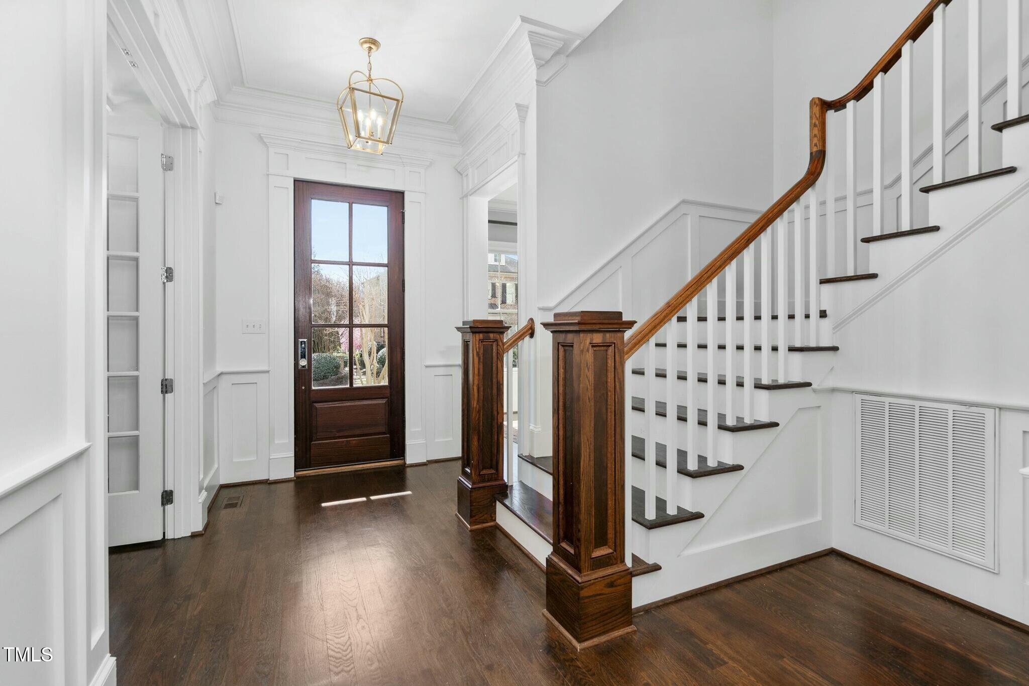 543 Guilford Circle Raleigh, NC 27608 - Photo 5 of 62 a view of an entryway with wooden floor and stairs
