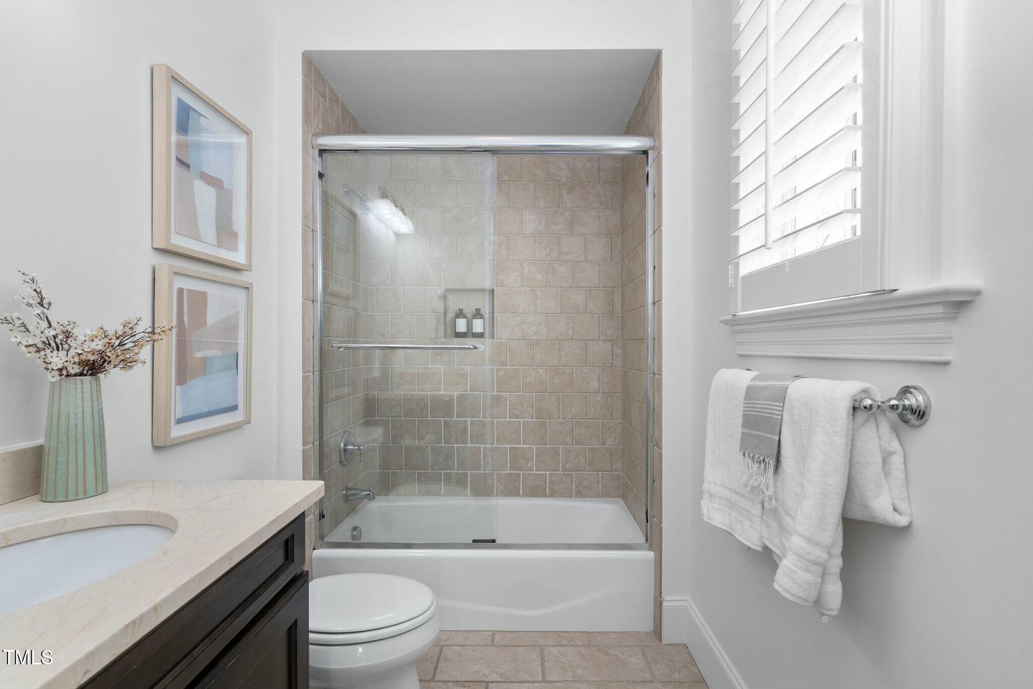 543 Guilford Circle Raleigh, NC 27608 - Photo 52 of 62 a bathroom with a granite countertop bathtub shower sink vanity and toilet