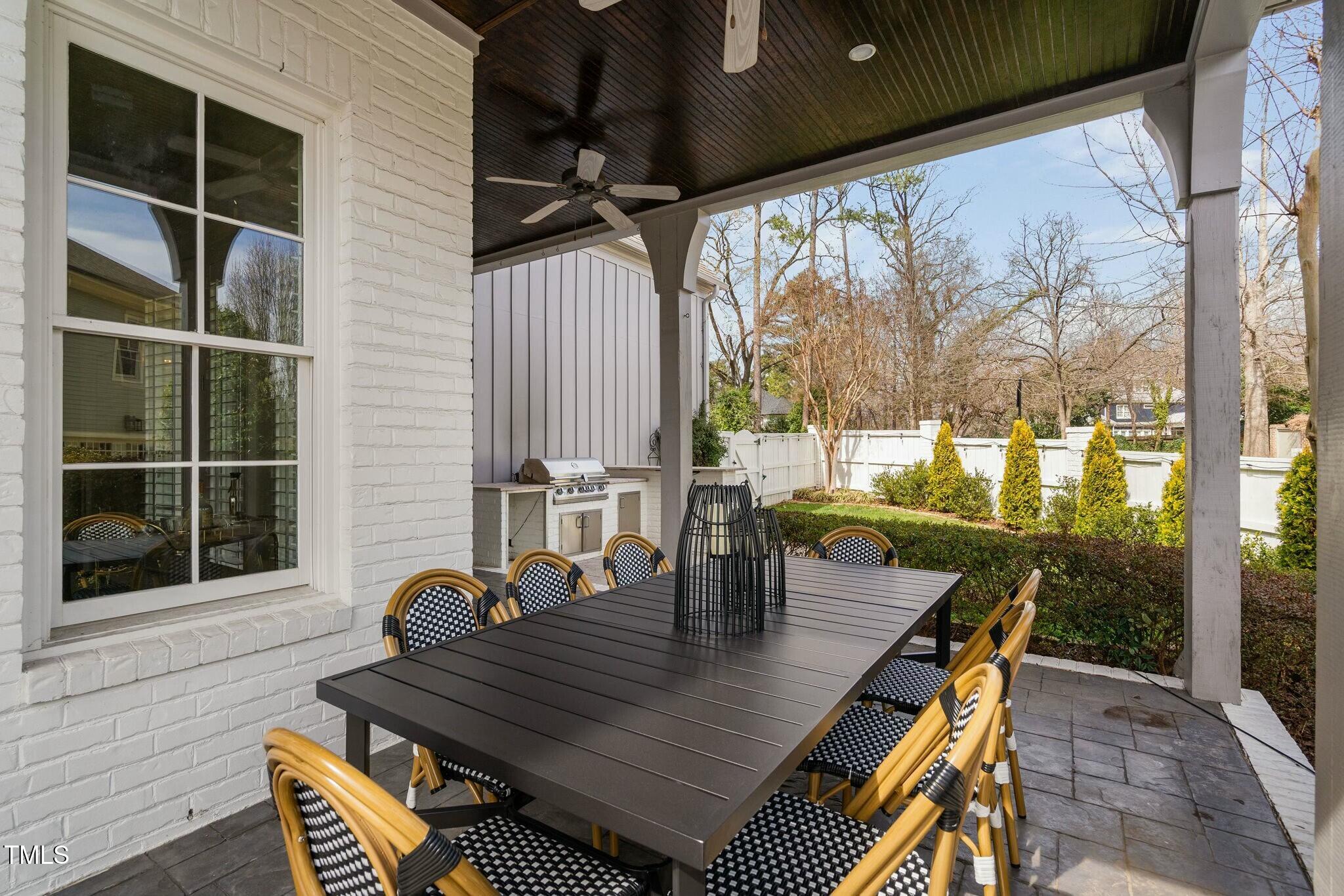 543 Guilford Circle Raleigh, NC 27608 - Photo 56 of 62 a view of a patio with table and chairs and wooden floor