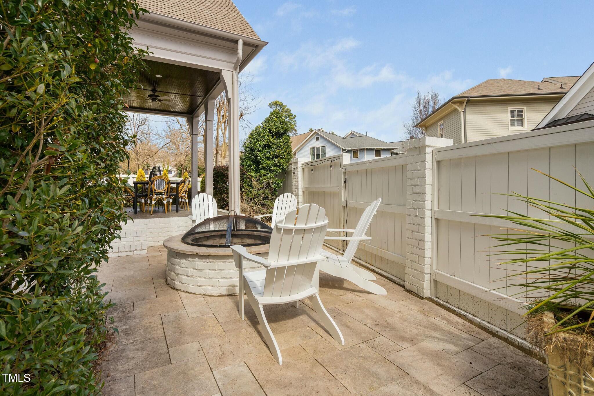 543 Guilford Circle Raleigh, NC 27608 - Photo 57 of 62 a view of a patio with table and chairs and potted plants