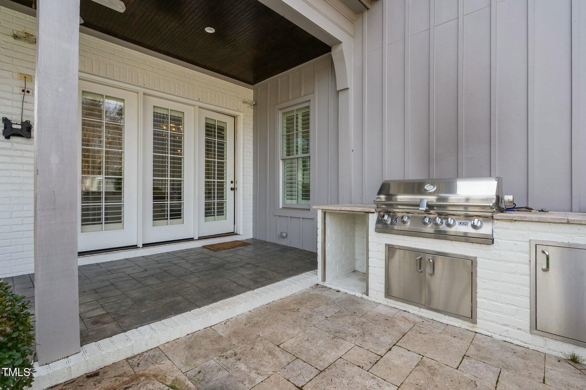 543 Guilford Circle Raleigh, NC 27608 - Photo 58 of 62 a kitchen with kitchen island a sink cabinets and stainless steel appliances
