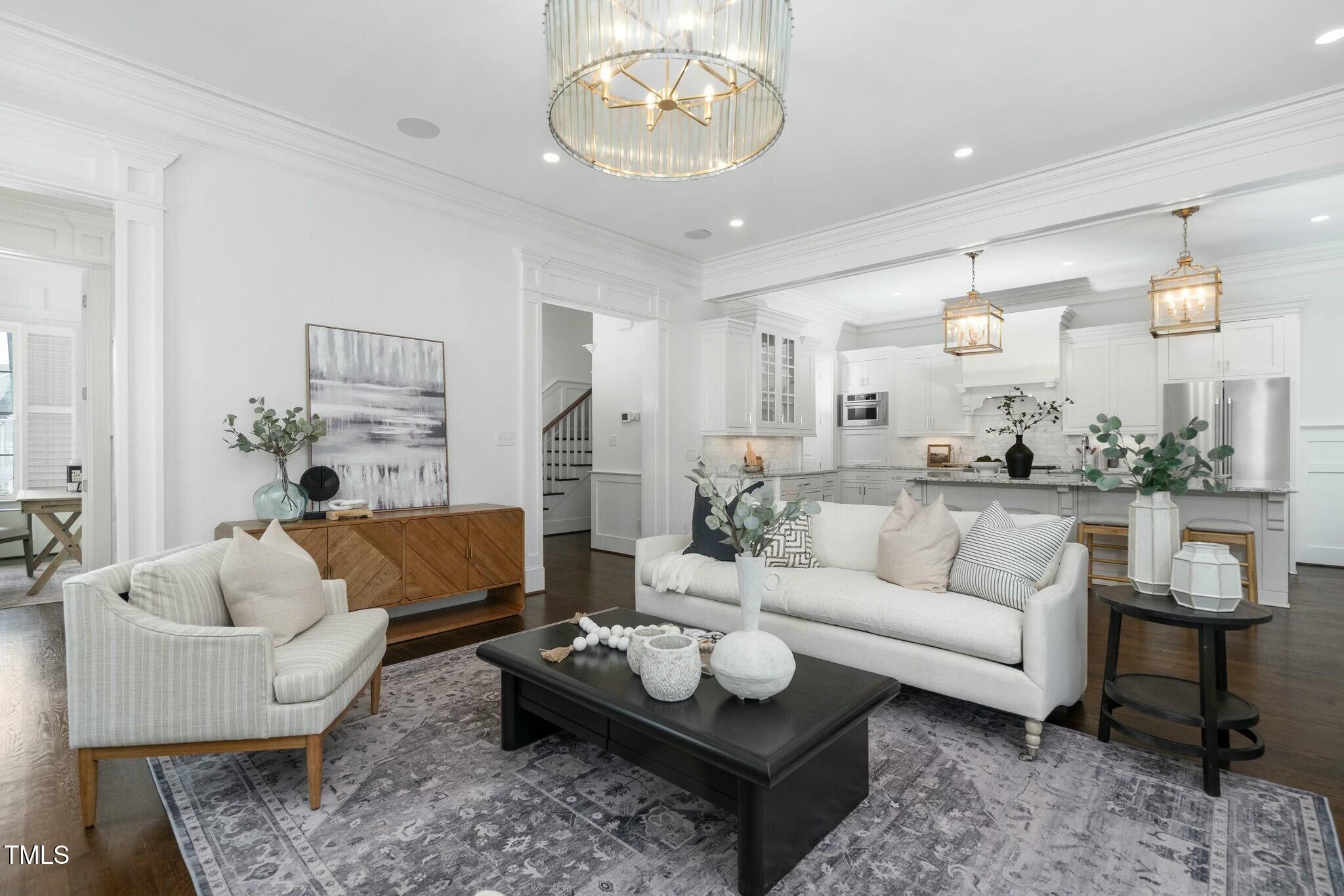 543 Guilford Circle Raleigh, NC 27608 - Photo 8 of 62 a living room with furniture and a chandelier