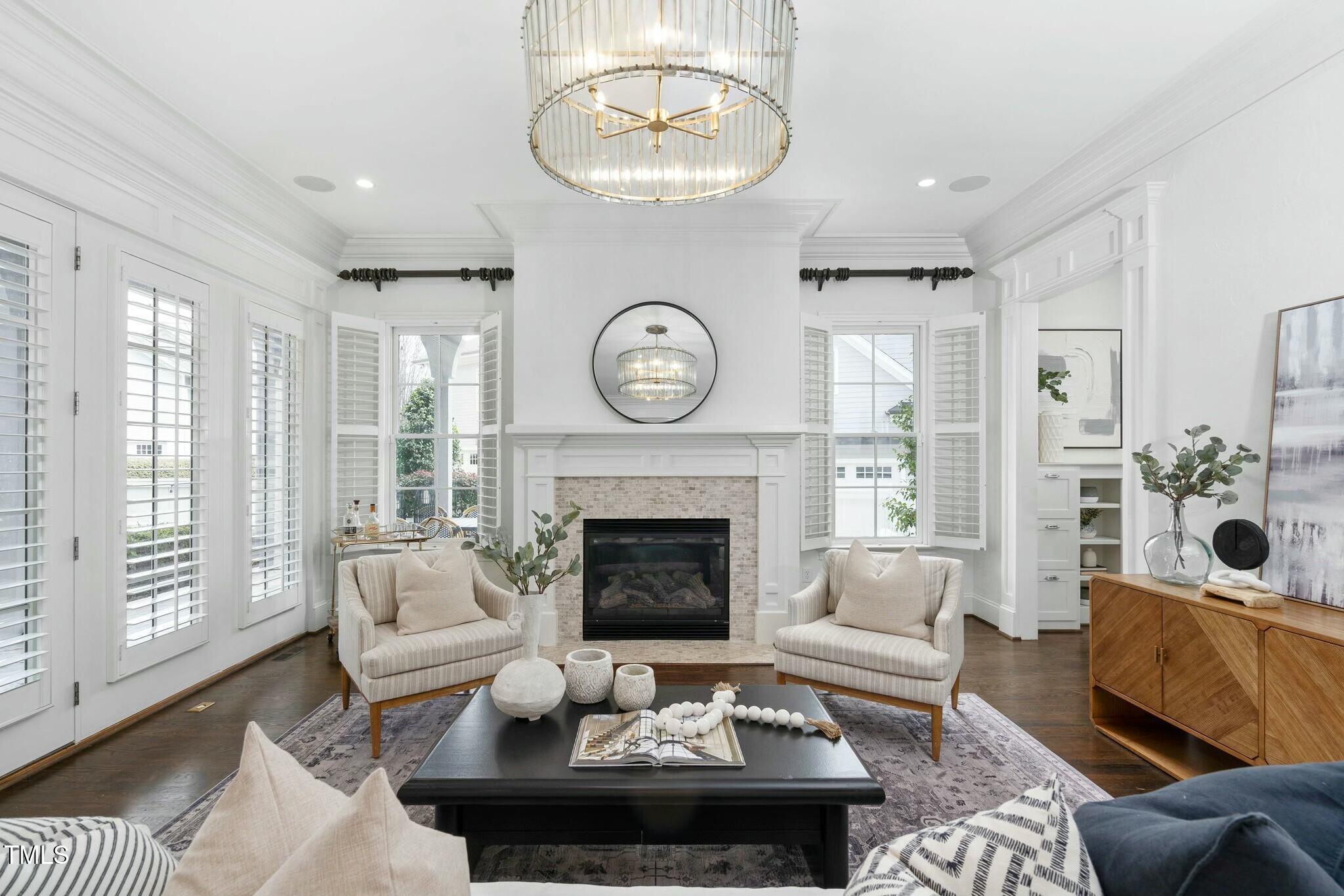 543 Guilford Circle Raleigh, NC 27608 - Photo 10 of 62 a living room with furniture a fireplace and a large window