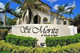 a view of a sign under a palm tree