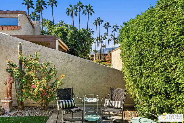 a view of a chairs and table in patio