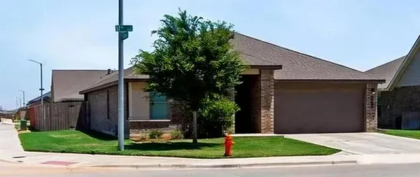 a house with yard and a large parking space