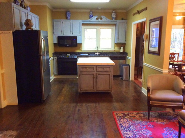 6370 New Forsyth Road Macon, GA 31210 - Photo 8 of 32 a kitchen with granite countertop wooden floors a stove and a refrigerator