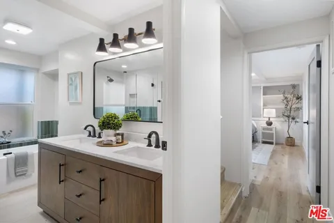 a bathroom with a double vanity sink and a mirror