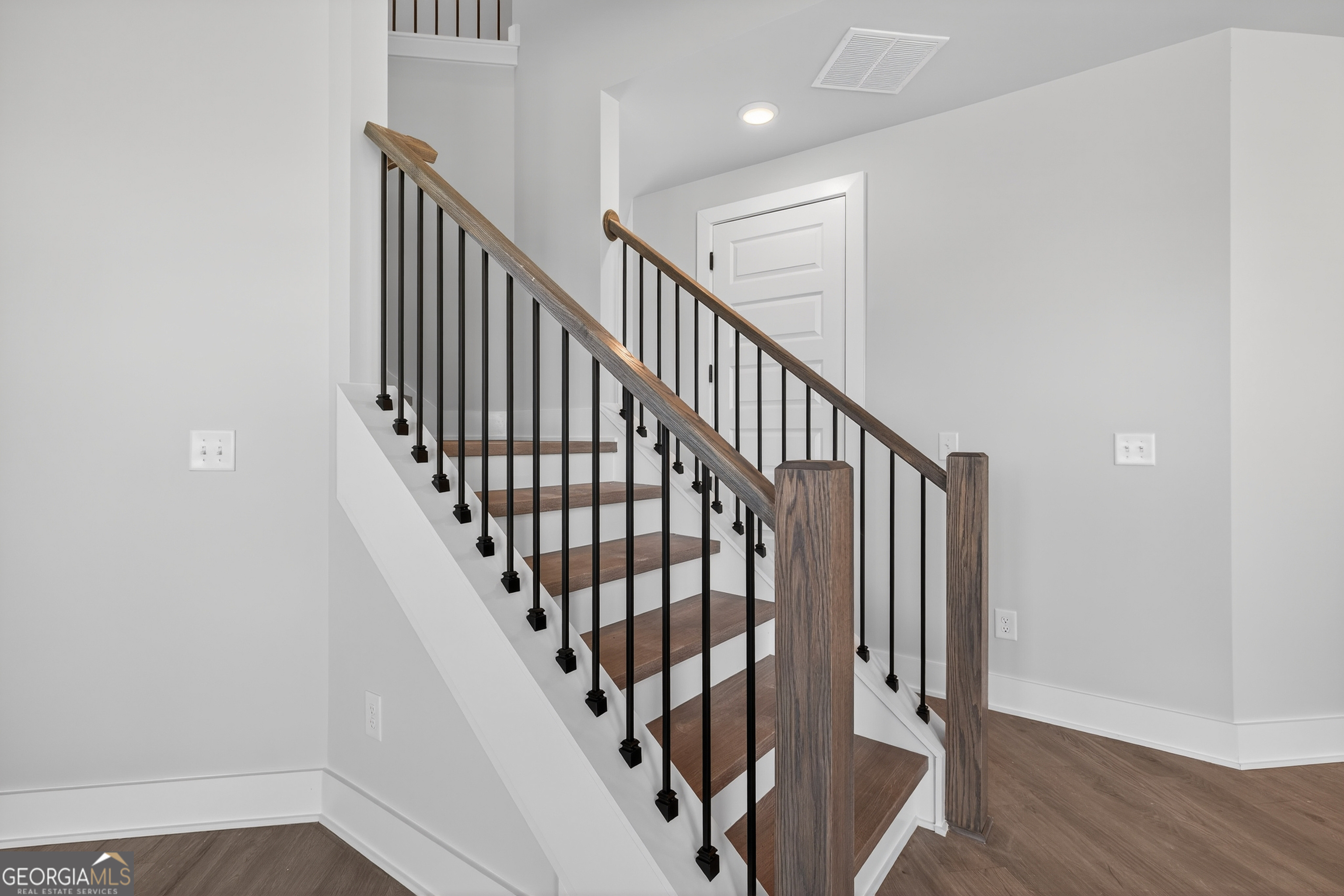 112 Patillo Manor, Unit 3 Stockbridge, GA 30281 - Photo 39 of 59 a view of staircase with wooden floor and white walls