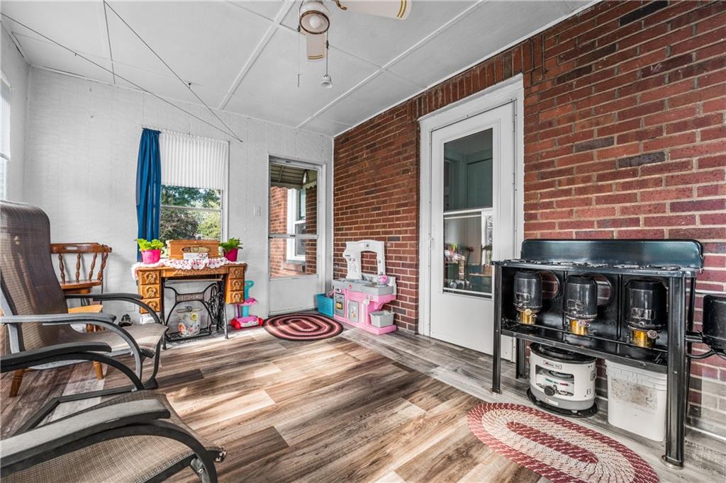 332 Pulaski Road Pulaski, PA 16143 - Photo 24 of 33 a living room with furniture and a fireplace