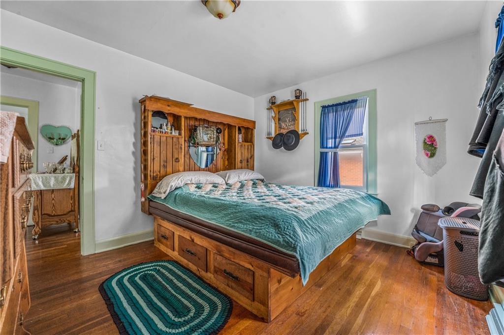 332 Pulaski Road Pulaski, PA 16143 - Photo 26 of 33 a bedroom with a bed and wooden floor