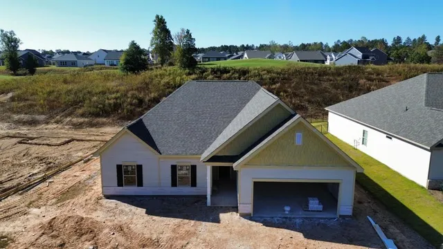 a aerial view of a house with a yard and garage
