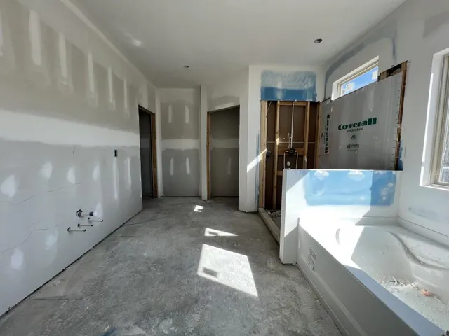 a large bathroom with a tub and shower