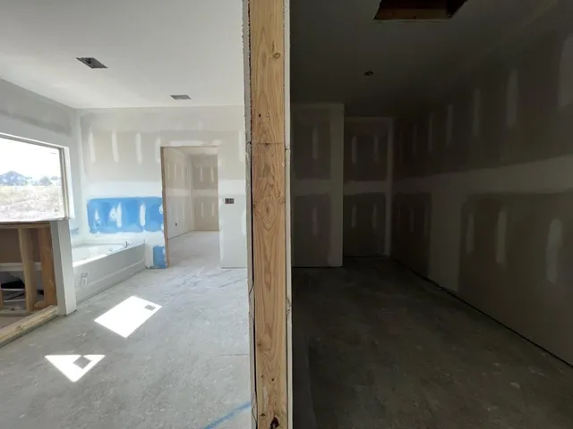 a view of a hallway with furniture and a fireplace