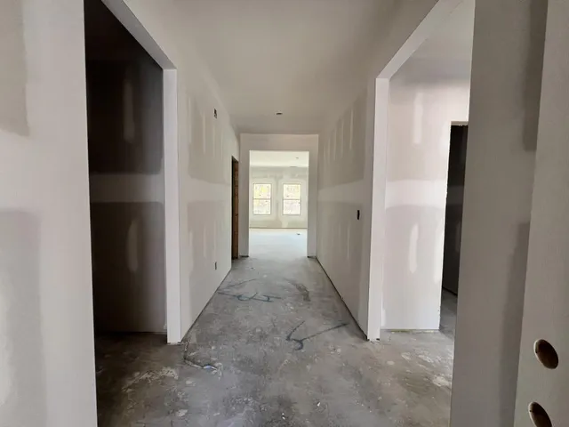 a view of a hallway to rooms